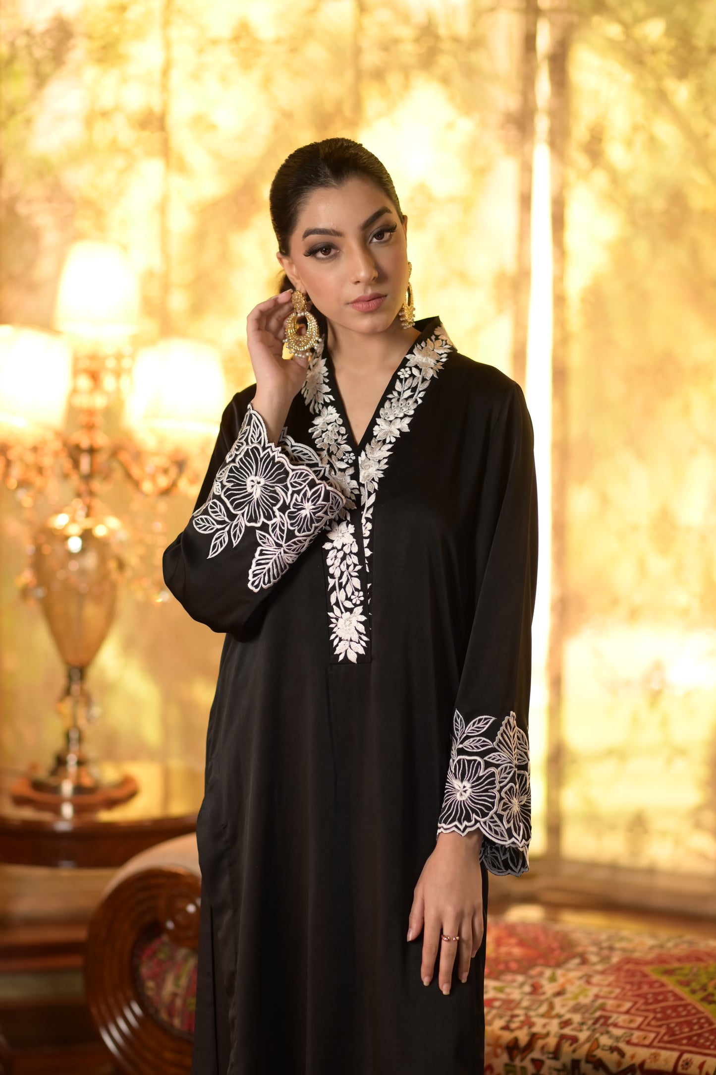 Black kurta with white embroidery on neck and arms, paired with cutwork culottes from Eid Edit collection.