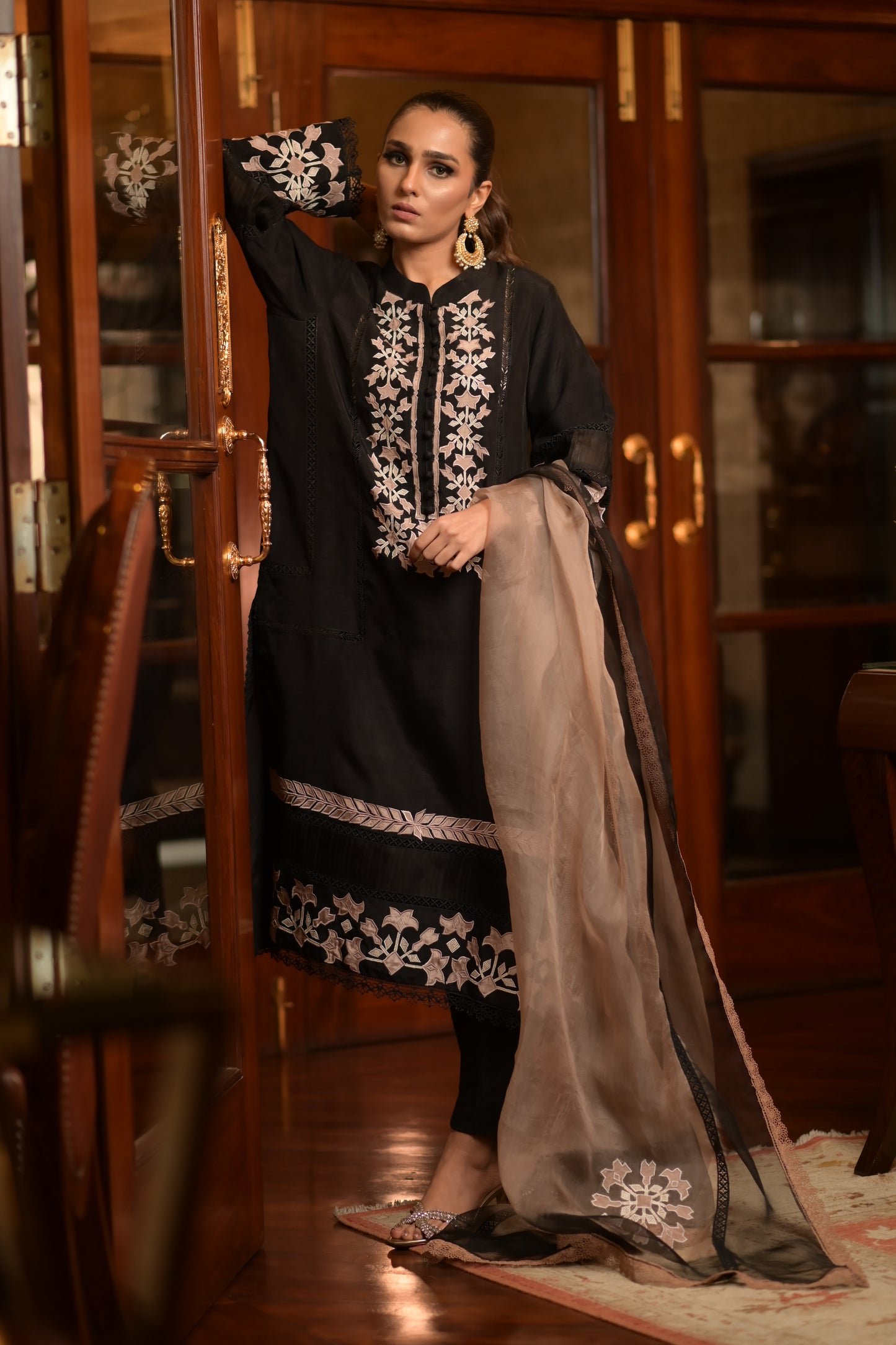 Black Eid Edit '24 shirt with unique applique work and two-toned organza dupatta, featuring pastel beige and off-white designs.